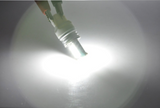 7443 LED bulb producing a strong white light beam for reverse or marker use.