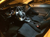 Interior of a Mitsubishi Evo X with factory lighting, showing a dim yellowish glow.